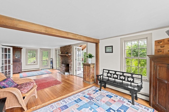 146 Chief Justic Cushing Hwy, Scituate, MA 02066 - living area featuring wood finished floors, a brick fireplace, a baseboard radiator, and beam ceiling
