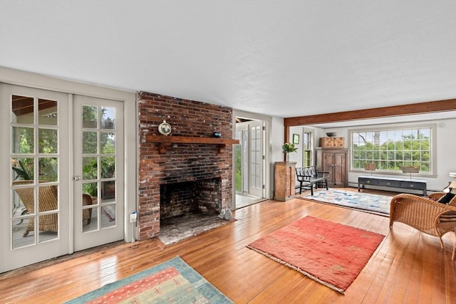 146 Chief Justic Cushing Hwy, Scituate, MA 02066 - living area featuring hardwood / wood-style flooring, french doors, and a baseboard heating unit