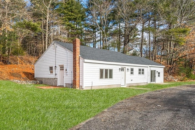 view of outbuilding with a lawn