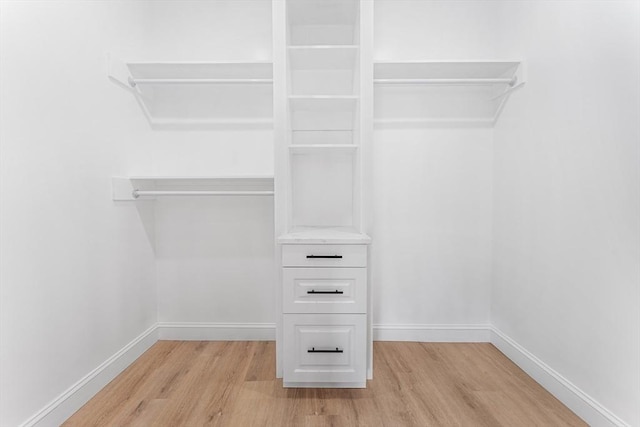 spacious closet featuring light hardwood / wood-style floors