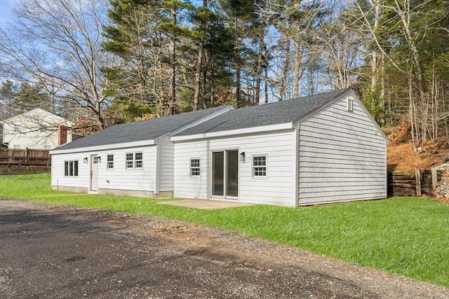 view of outbuilding with a lawn