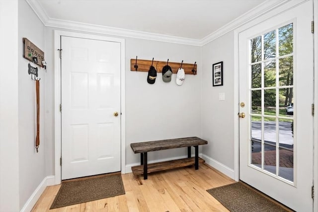 mudroom with baseboards, ornamental molding, and light wood finished floors