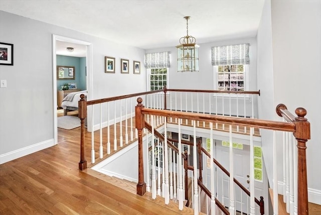 stairs with baseboards and wood finished floors
