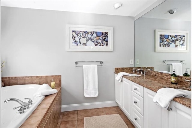 full bathroom with baseboards, tile patterned flooring, a bath, and vanity