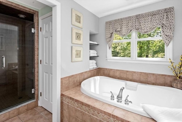 full bathroom featuring tile patterned flooring, a shower stall, and a bath