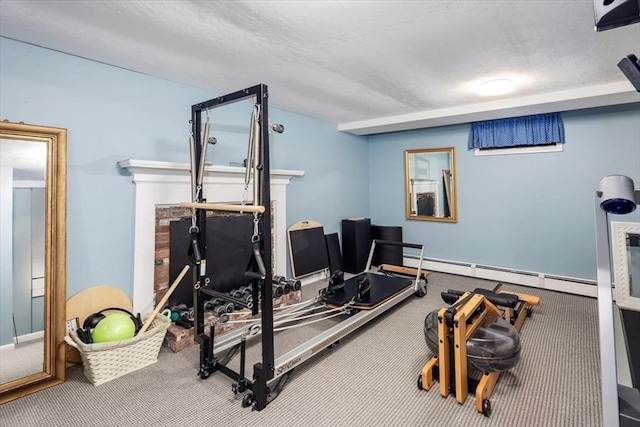 workout area with baseboard heating and carpet