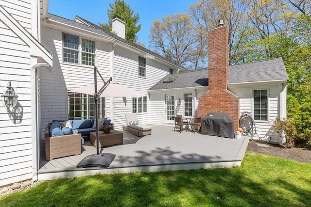 rear view of house with a yard, a chimney, an outdoor living space, and a deck