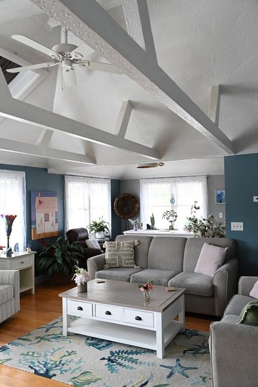 72 Lakeview Pl, Taunton, MA 02780 - living area featuring wood finished floors, beam ceiling, ceiling fan, and high vaulted ceiling