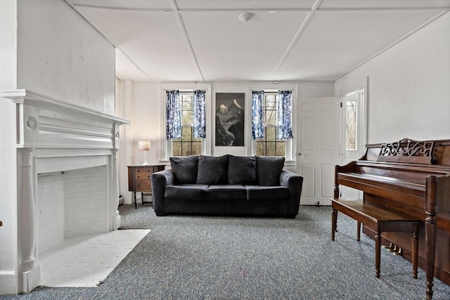 living area with carpet and a fireplace