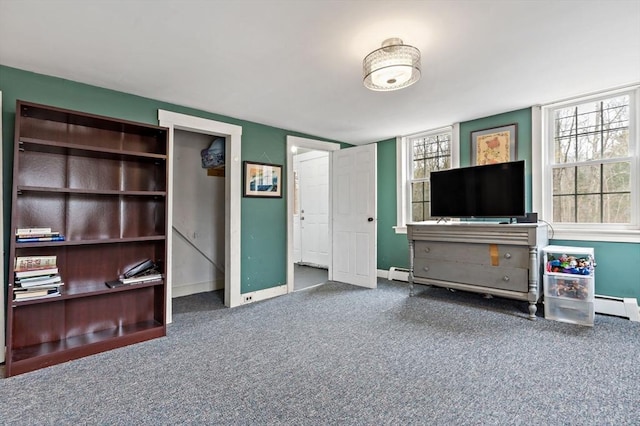 living room featuring baseboard heating, baseboards, and carpet floors