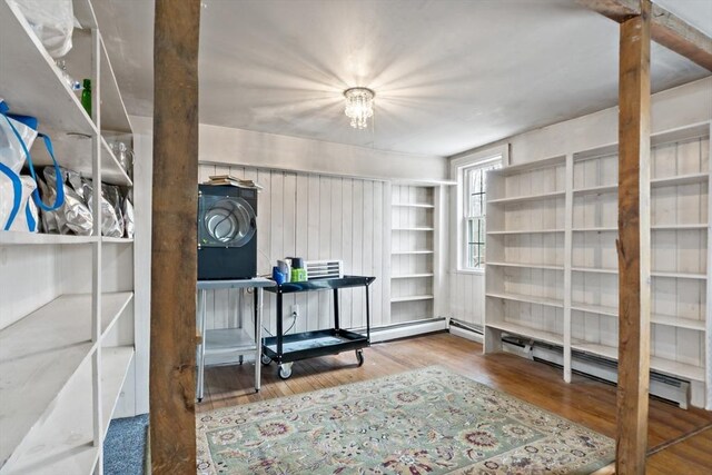 office space with built in shelves and wood finished floors