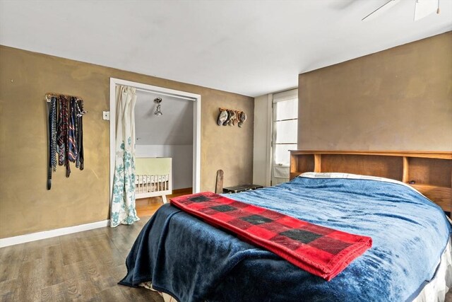 bedroom featuring wood finished floors and baseboards