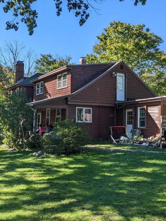 view of front of house featuring a front yard and a chimney