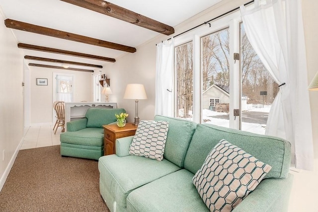 carpeted living room featuring beamed ceiling