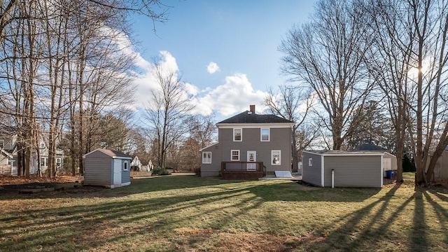 rear view of property featuring a shed and a lawn