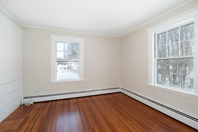 empty room featuring crown molding, hardwood / wood-style flooring, and baseboard heating