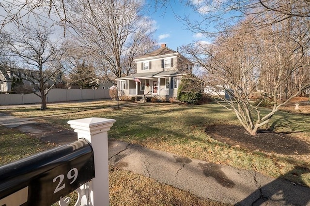 view of front of house with covered porch and a front lawn