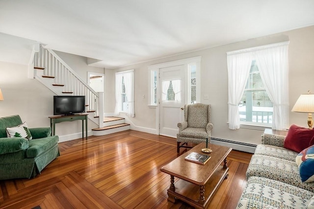 living room with a wealth of natural light and a baseboard radiator