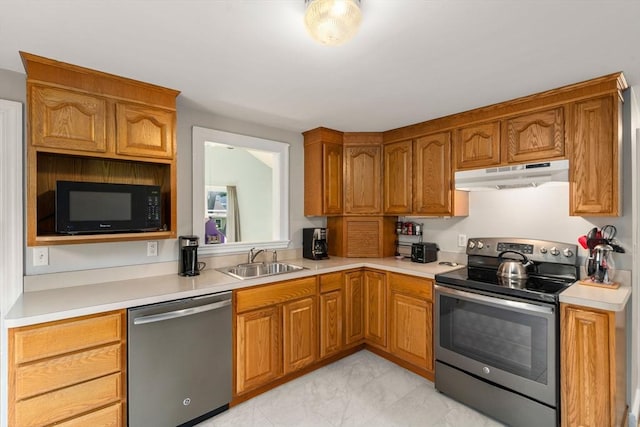 72 Lyall St, Boston, MA 02132 - kitchen with stainless steel appliances, under cabinet range hood, light countertops, and brown cabinetry
