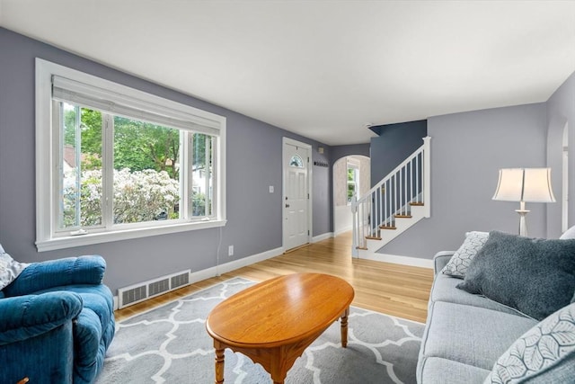 72 Lyall St, Boston, MA 02132 - living area with arched walkways, wood finished floors, and stairs