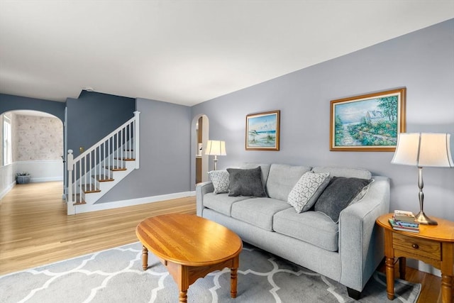 72 Lyall St, Boston, MA 02132 - living area with arched walkways, wood finished floors, and stairway