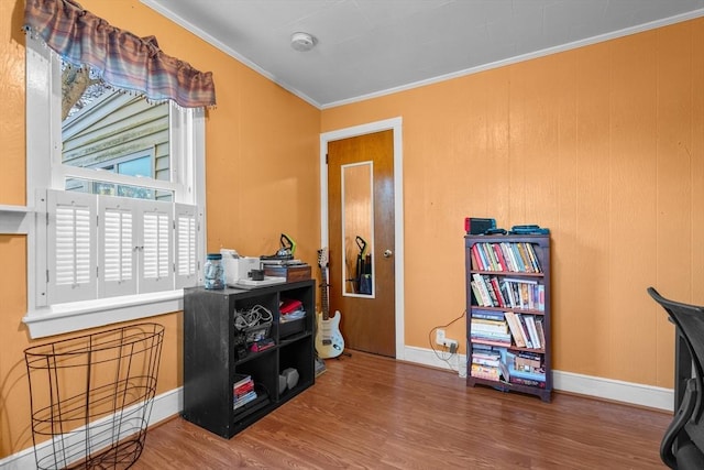 office featuring a healthy amount of sunlight, hardwood / wood-style floors, and crown molding