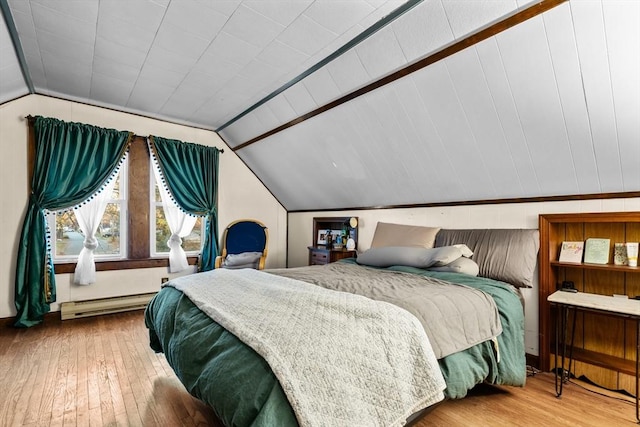 bedroom featuring a baseboard radiator, hardwood / wood-style floors, and vaulted ceiling