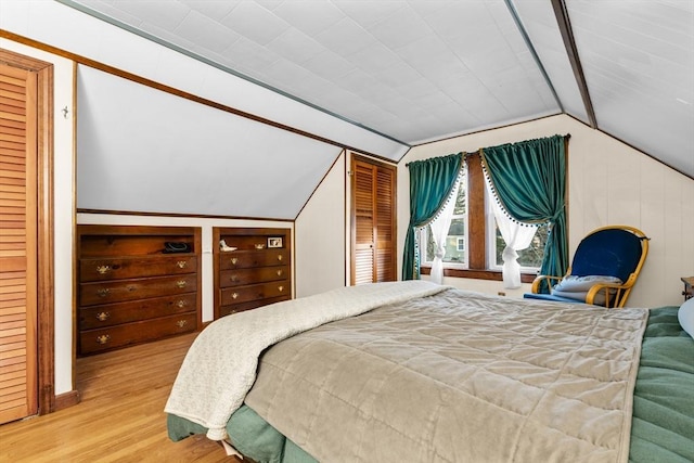 bedroom featuring lofted ceiling and light hardwood / wood-style floors