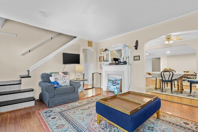 living room featuring hardwood / wood-style floors and ceiling fan