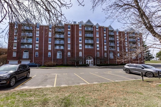 view of building exterior with uncovered parking