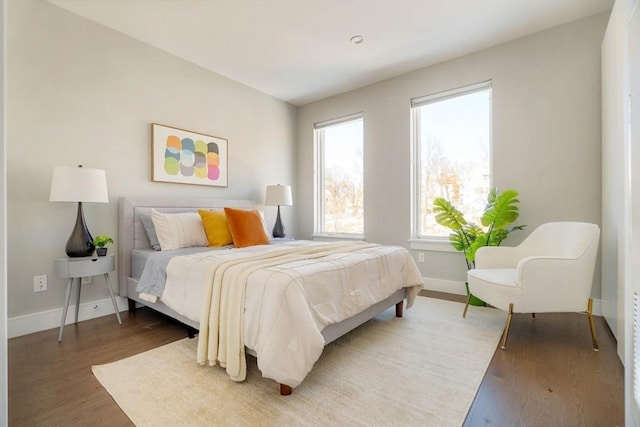 bedroom featuring dark wood-style flooring and baseboards