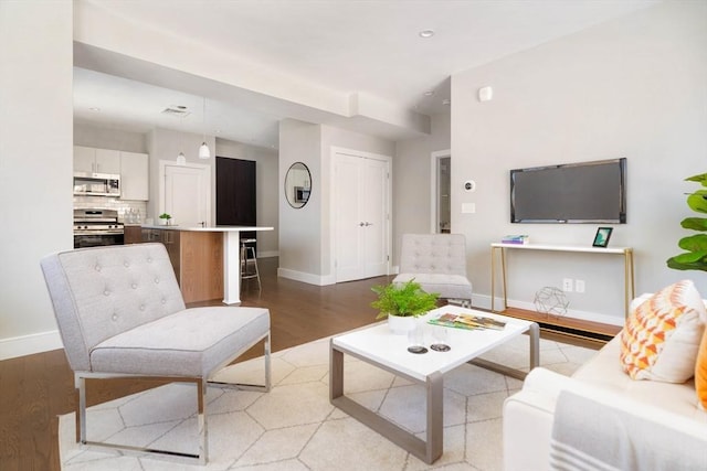 living room with light wood-type flooring, baseboards, and recessed lighting