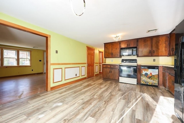 kitchen featuring light hardwood / wood-style flooring and black appliances