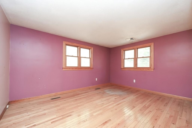 unfurnished room with light wood-type flooring