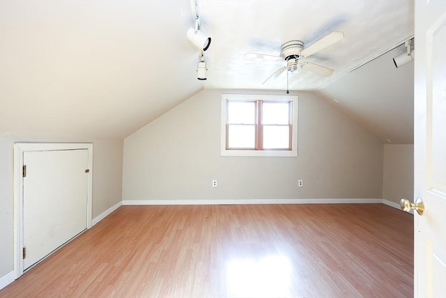 additional living space featuring lofted ceiling, ceiling fan, and light wood-type flooring