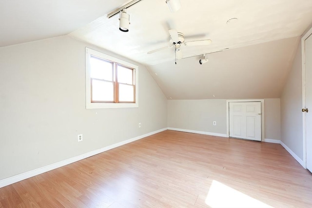 additional living space featuring ceiling fan, lofted ceiling, and light wood-type flooring