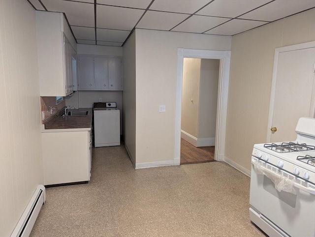 kitchen with washer / dryer, white range with gas cooktop, baseboards, a drop ceiling, and baseboard heating