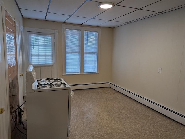 interior space with baseboard heating, a paneled ceiling, and white range with gas stovetop