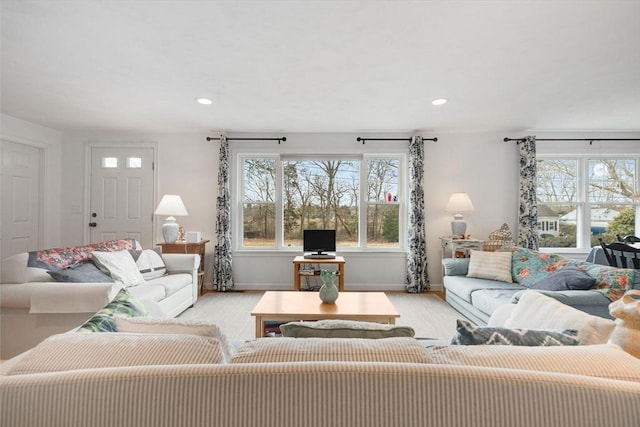 living area featuring recessed lighting, baseboards, and plenty of natural light