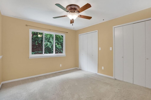 43 Meadowbrook Ln Unit 43, Palmer, MA 01069 - unfurnished bedroom with multiple closets, carpet flooring, ornamental molding, and ceiling fan