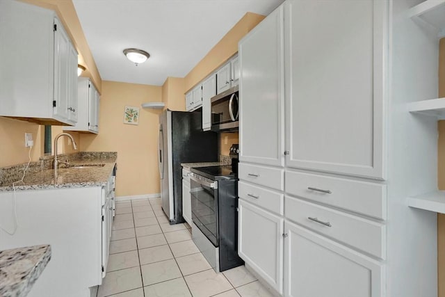 43 Meadowbrook Ln Unit 43, Palmer, MA 01069 - kitchen with appliances with stainless steel finishes, white cabinetry, light stone counters, and light tile patterned floors