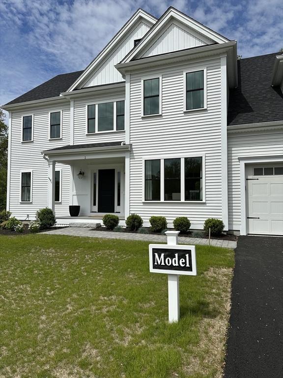 2 Libbey Ln, Grafton, MA 01536 - view of front of home featuring an attached garage, board and batten siding, a front lawn, and asphalt driveway