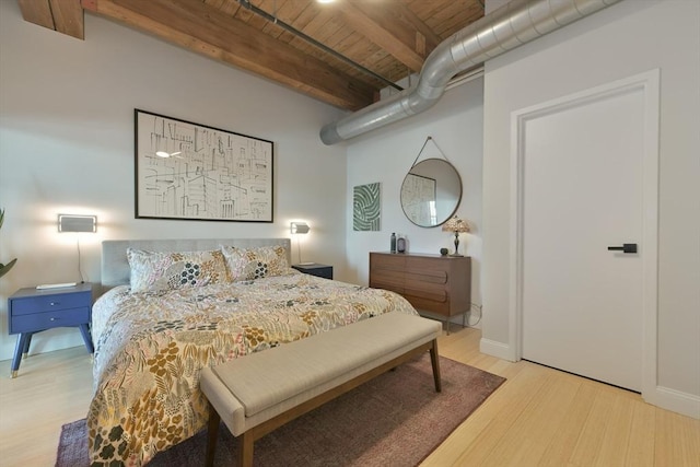 bedroom with beamed ceiling, wood finished floors, wood ceiling, and baseboards