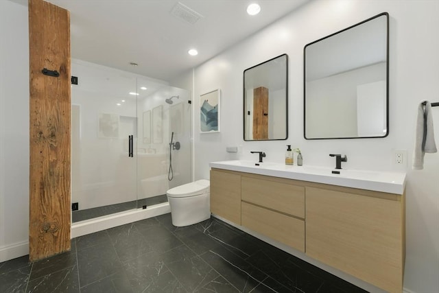 bathroom with marble finish floor, double vanity, toilet, a stall shower, and a sink