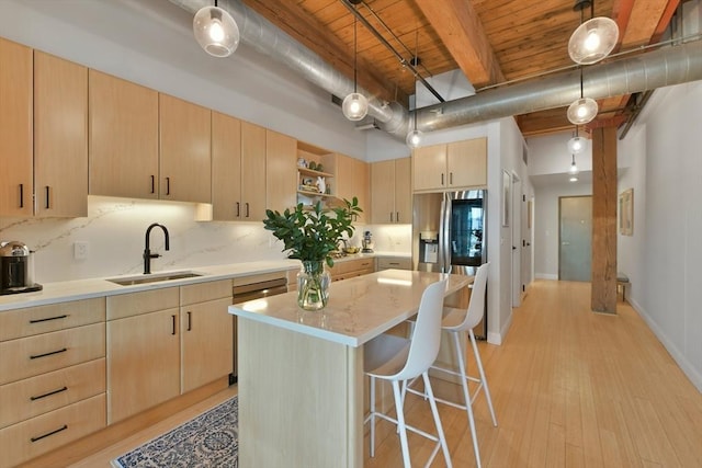 kitchen with light brown cabinetry, open shelves, a sink, and stainless steel fridge with ice dispenser