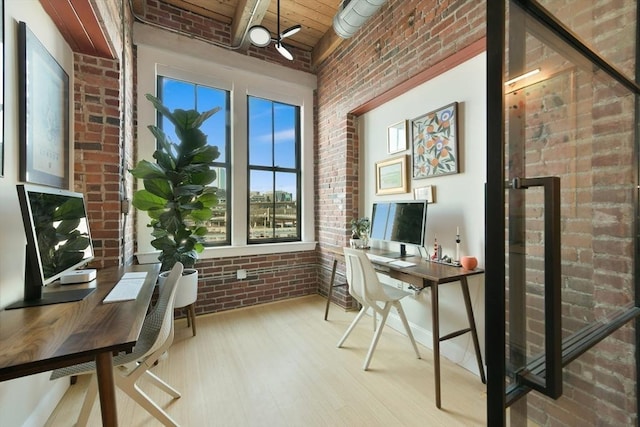 office space with wood ceiling, brick wall, and wood finished floors