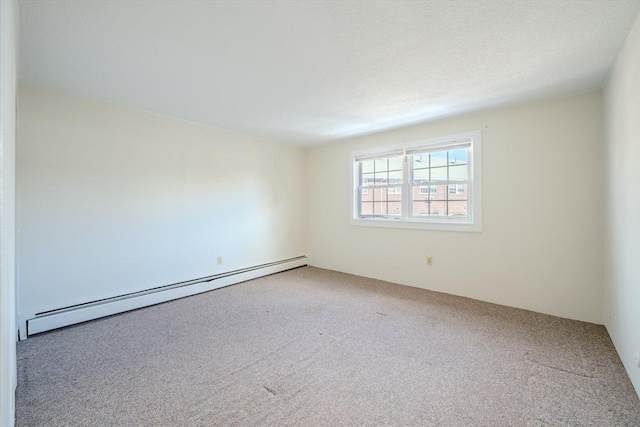 unfurnished room with a baseboard radiator and carpet floors