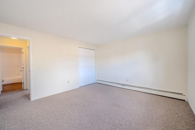 spare room with a baseboard radiator and carpet floors