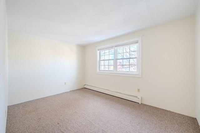 carpeted spare room featuring a baseboard radiator