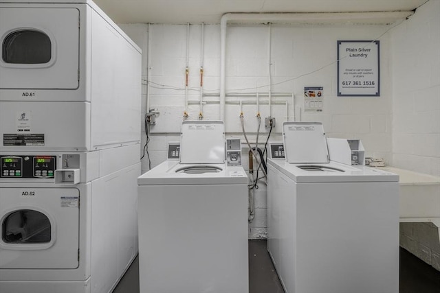 washroom with stacked washer / drying machine and washer and clothes dryer